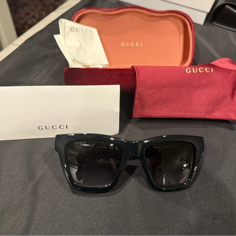 Gucci GG1714S cat-eye sunglasses with a black frame and solid grey lenses